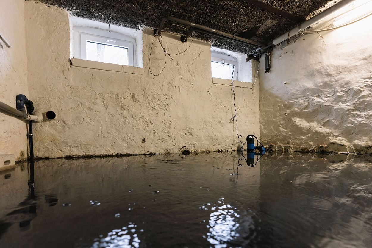 A basement filled with water, showing a window and sink, emphasizing the urgency for water damage restoration in Honolulu, HI.